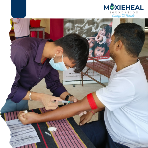 Health experts examining an elderly woman during the Free Health Check-up Camp organized by Moxieheal Foundation.