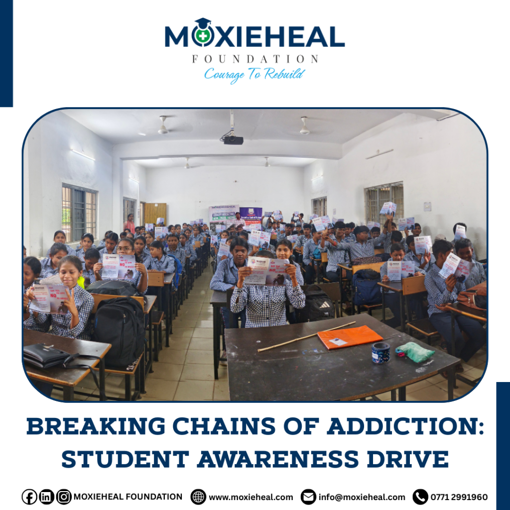 Students holding flyers above their heads during the Drug-Free Awareness Seminar by Moxieheal Foundation.