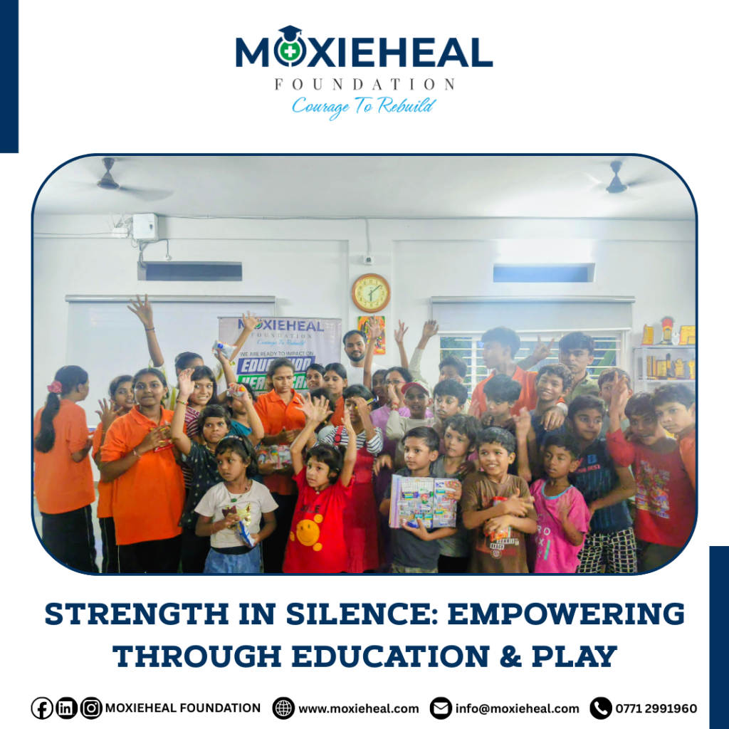 Children making sign-language gestures while holding gift hampers given by Moxieheal Foundation a Education NGO in Chhattisgarh